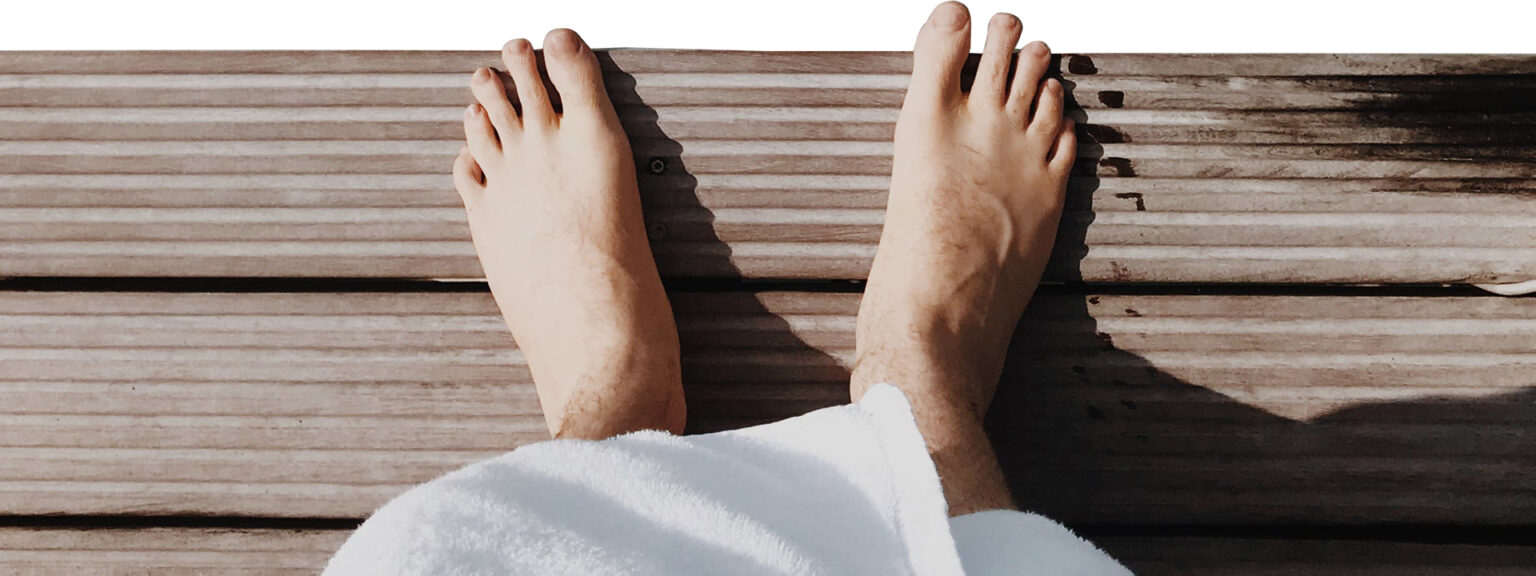 A person 's feet are shown on the ground.